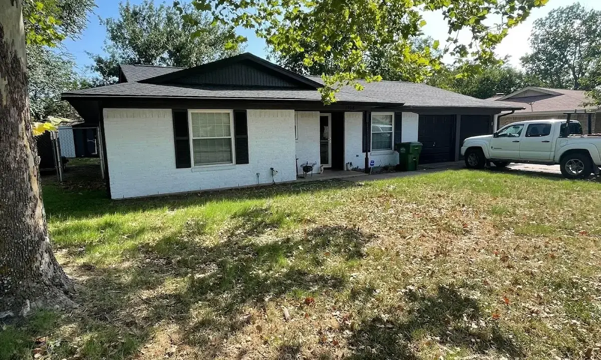 Professional roofing crew working on a residential roof in Southport